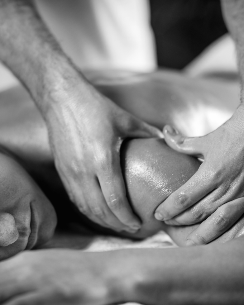 Young woman having relaxing arm and shoulder massage in cosmetology spa center, close up